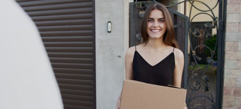 smiling girl with a box in her hands