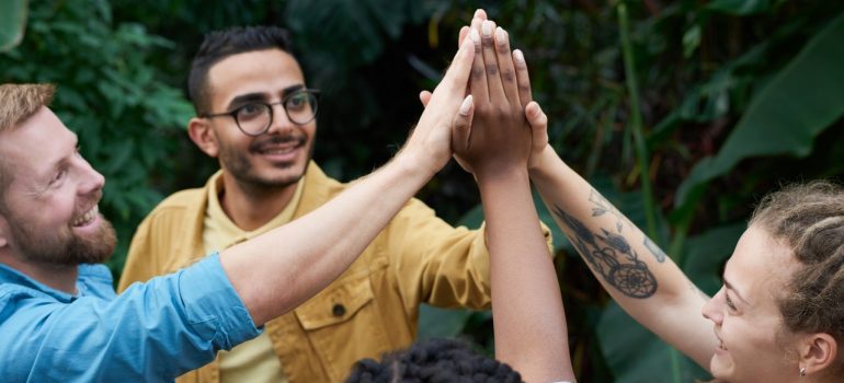 A group of friends high-fiving.