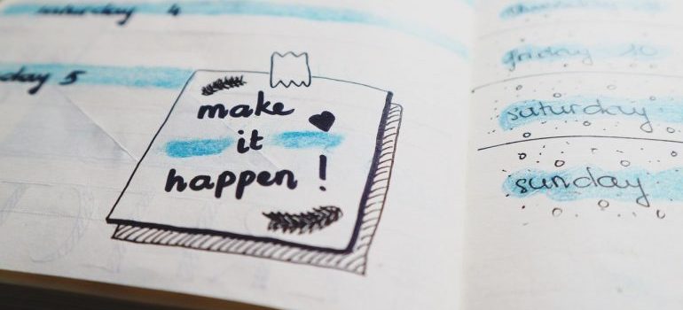 A notebook drawing saying "make it happen", as inspiration for hiring local movers in Northern VA.