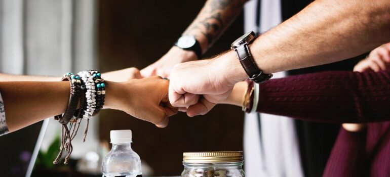 A group of people fist-bumping.