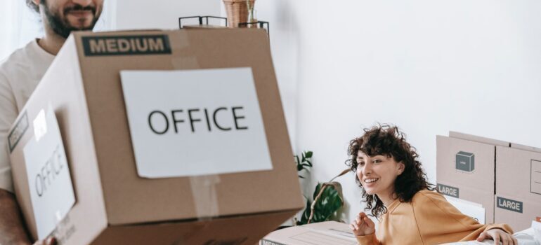 A man and woman waiting for commercial movers MD 