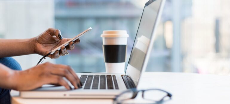 Person using laptop and phone