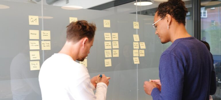 two men going through plans on a board