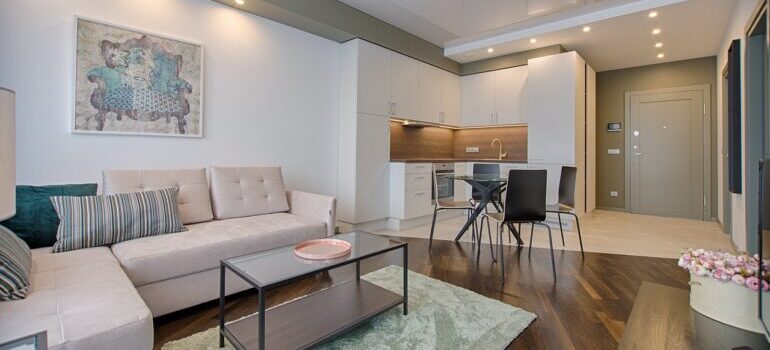 A nice decorated living room, dining room and the kitchen.