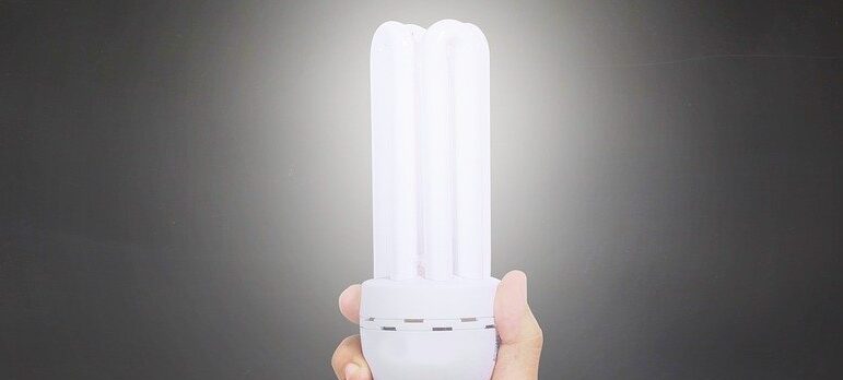 a hand holding a LED lamp