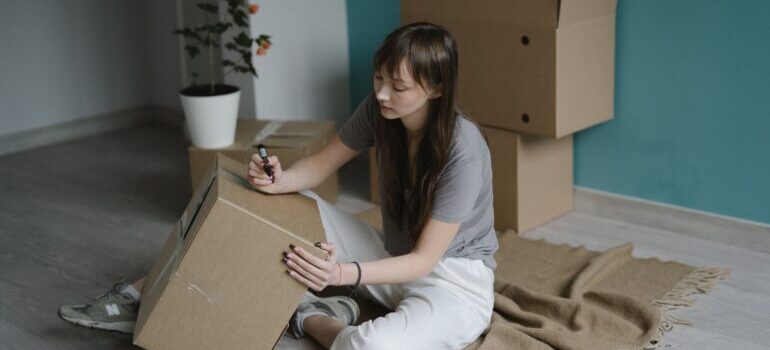 Woman labelling the box.