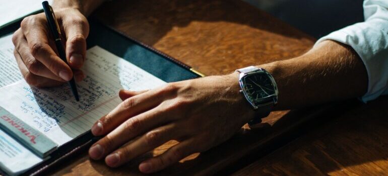 Man writing in his notebook.