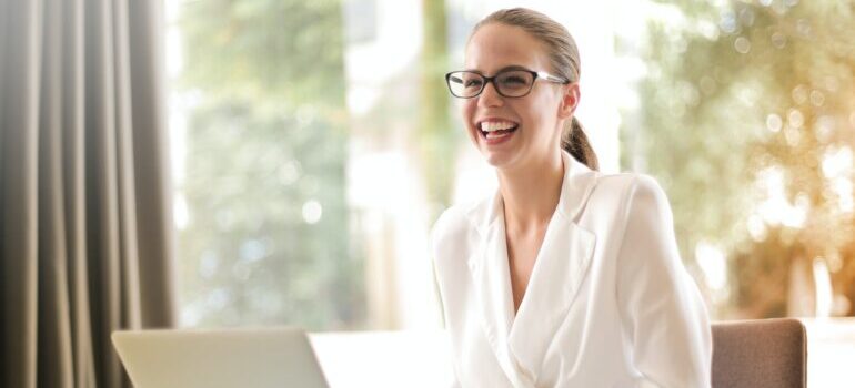 A woman sitting in an office and smiling