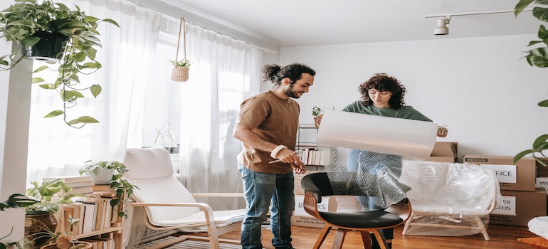 a couple packing their furniture