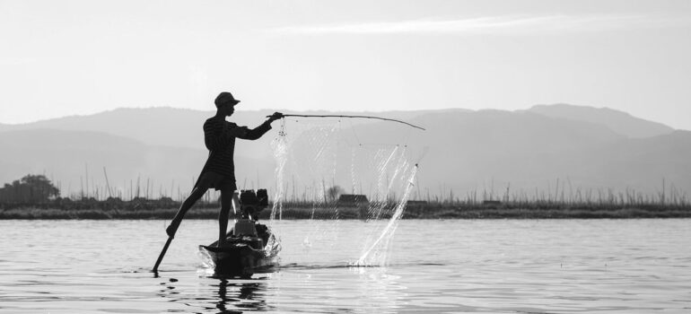 a picture of a person fishing on a lake