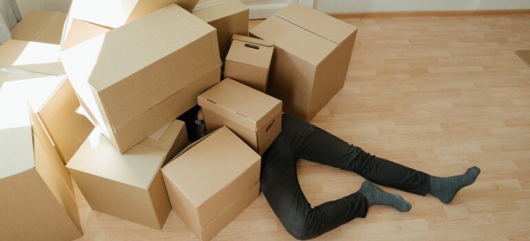 Man covered with boxes. 