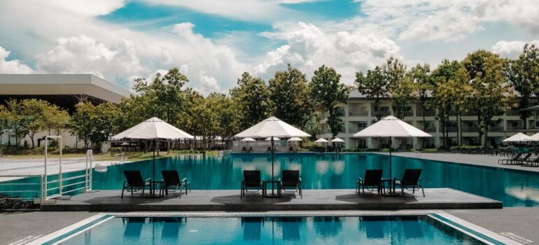 a large pool with a forest view in a resort-style location