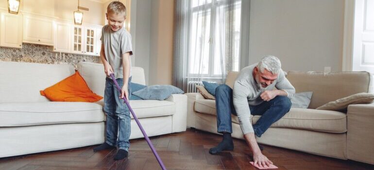 Father and son cleaning the floor.