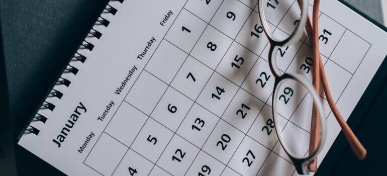 Eyeglasses on the calendar as symbol that right date can cut costs of your relocation to DC