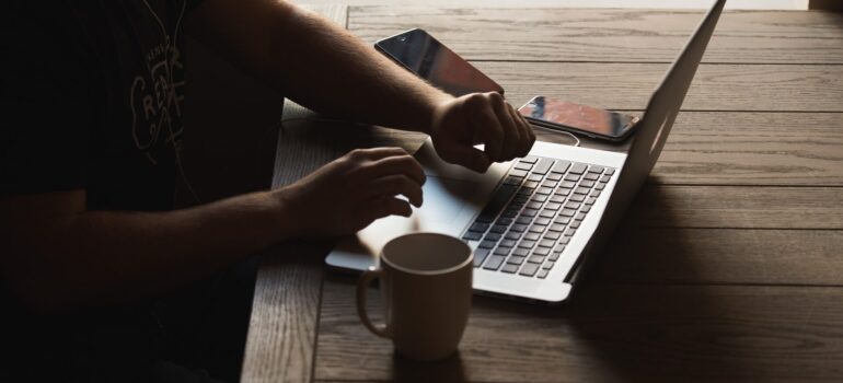 a person sitting in the dark getting ready to write a moving review after moving to MD