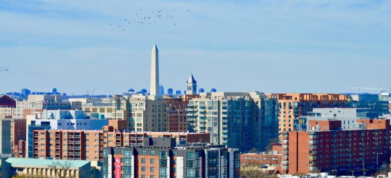 a panoramic view of the buildings in Washington DC, with the monument in the back