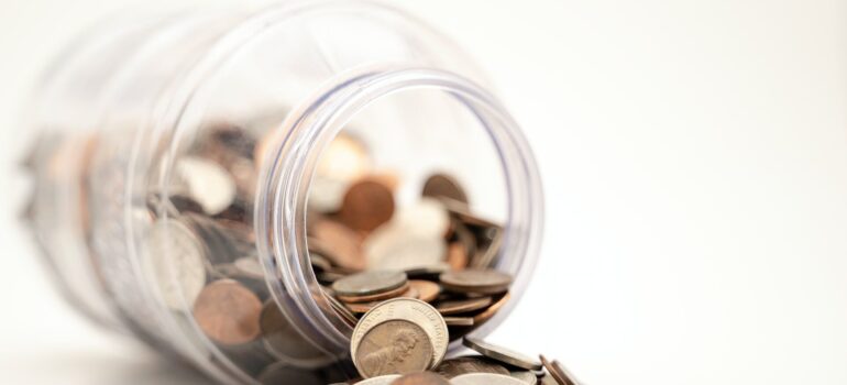 a jar of coins spilled on the table