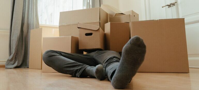 Person laying among boxes