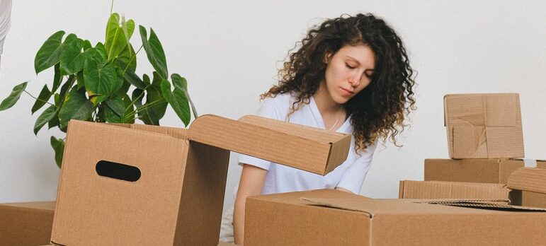 a girl packing for the move