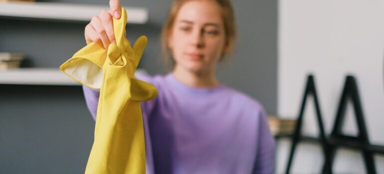 Person holding a cleaning glove