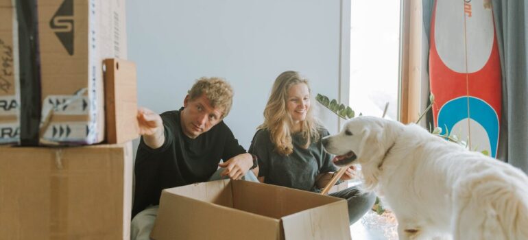 a couple sitting on the floor while unpacking, as something that must be done in the first week after moving to Washington DC