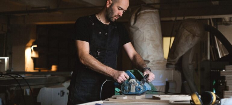 a man doing woodwork as he embarked on a task to build a low-maintenance home in Washington DC