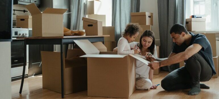 a family unpacking and discussing ways local movers can help you when settling in Gaithersburg MD 