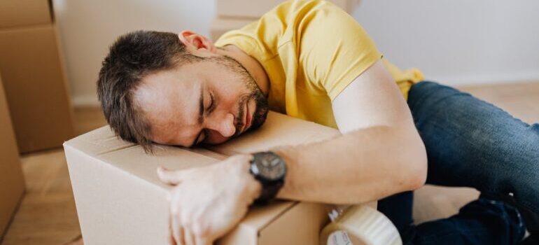 A man sleeping on the moving box