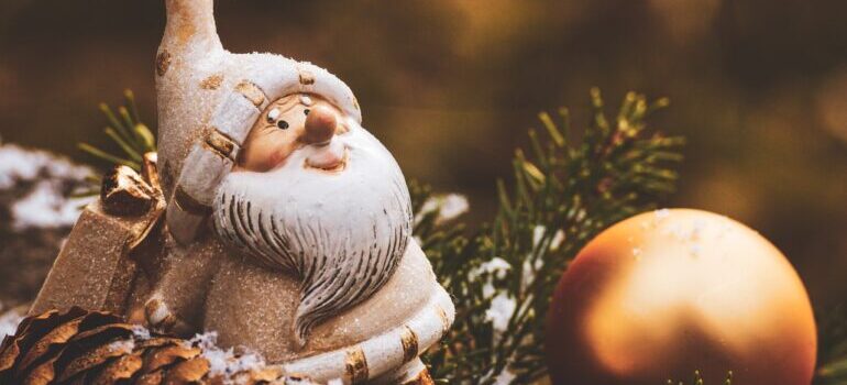 Santa Claus figure next to a Christmas ornament