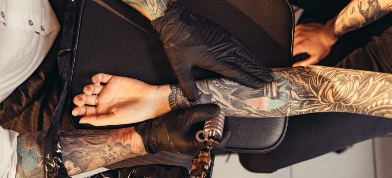 a person tattooing another person