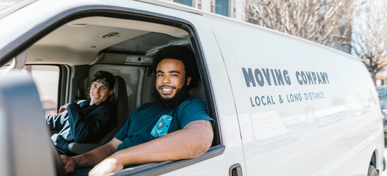 Moving company workers in a van