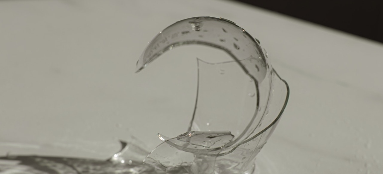 A broken glass symbolizing the risks of hiring cheap movers for your Washington relocation.