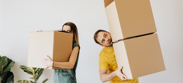 two people packing for the move