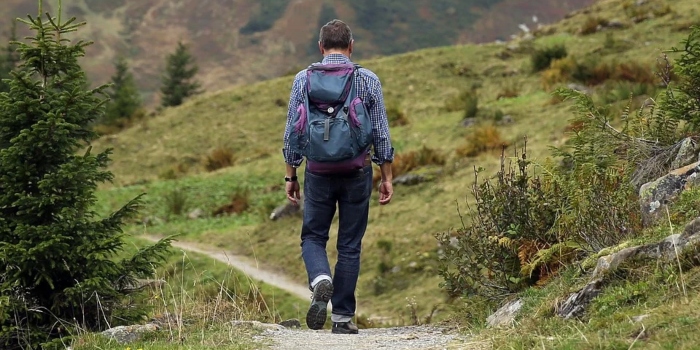 A man hikes along a beaten path.