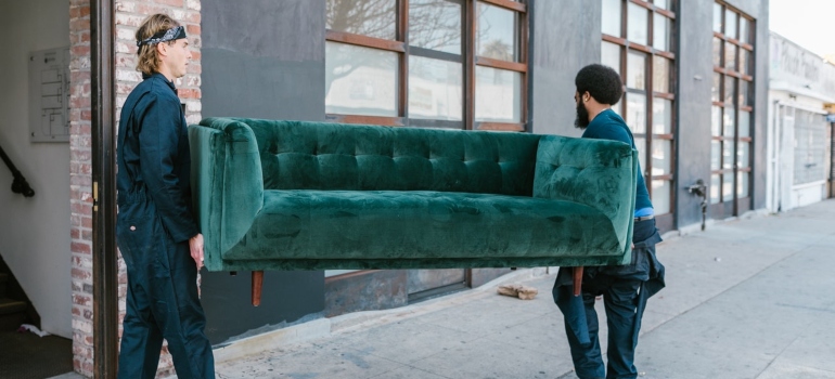 Two movers carrying a couch