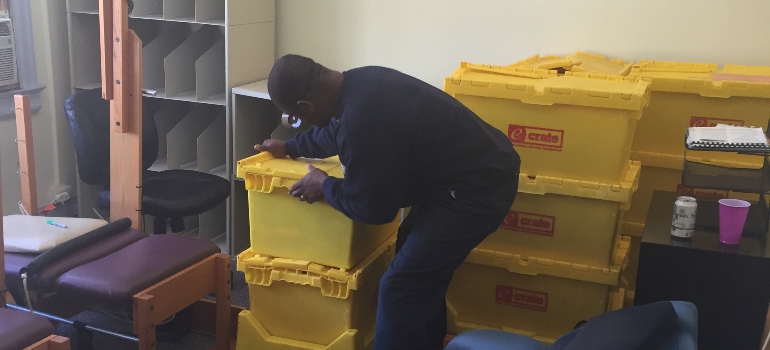 One of DC long distance movers packing a box