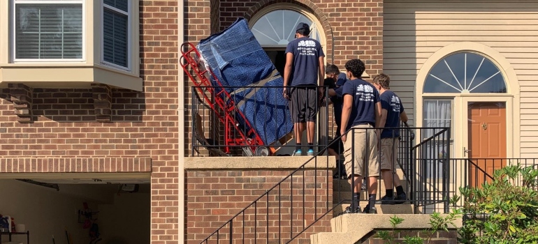 Movers moving a piano