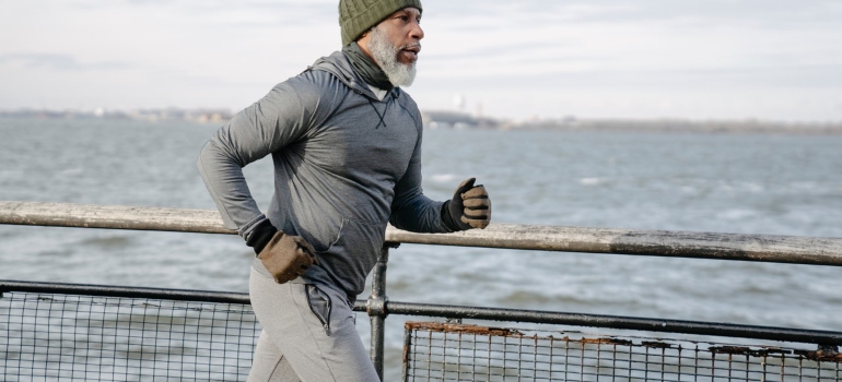 Man running next to a body of water 