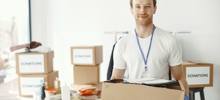 man holding labeled boxes