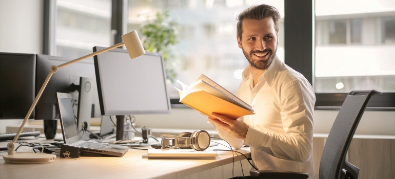 A happy businessman trying to organize your commercial move while the business is running