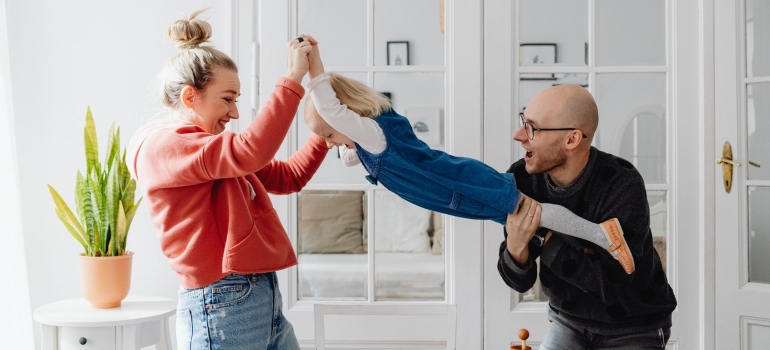 Aunt and uncle playing with their niece