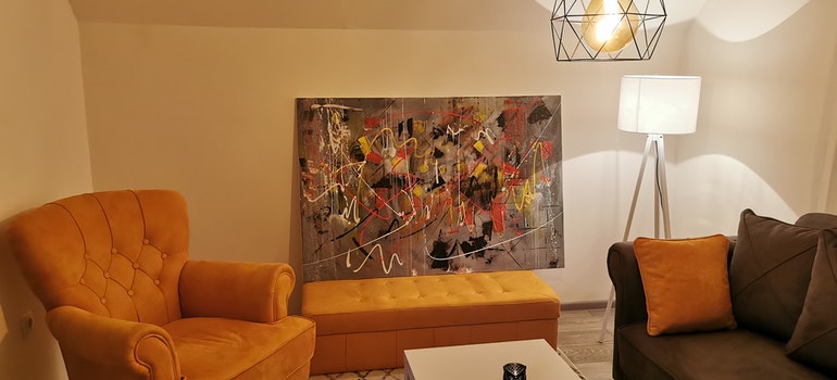 An armchair next to an abstract painting