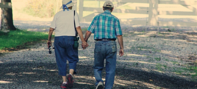 An old couple walking and holding hands