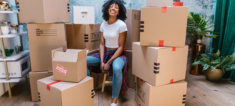 A woman surrounded by moving boxes