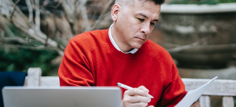 A man reading a file and a review