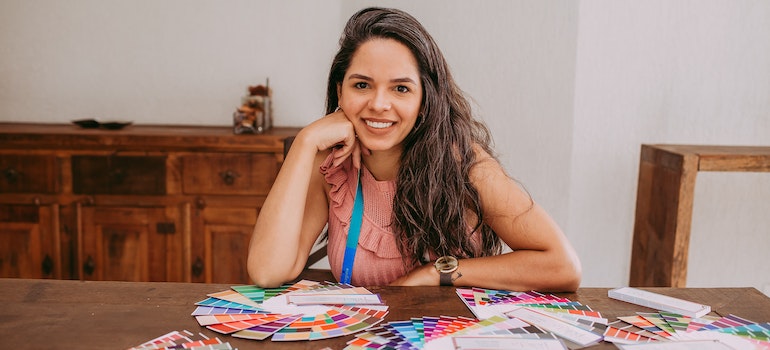 Woman with swatches on her table after reading what the most popular interior design trend in Alexandria in 2022 are