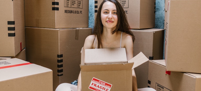 A woman holding a moving box