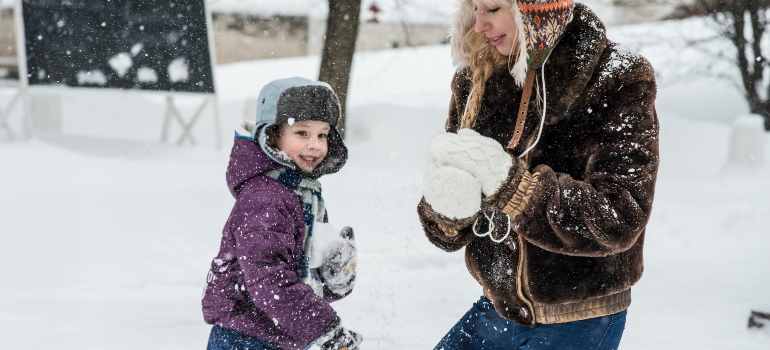 mother and kid on the snow