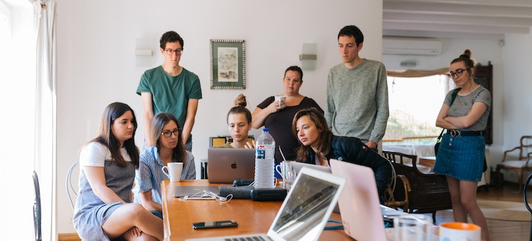 People gathered around an office desk