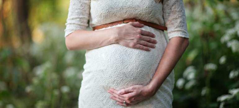 woman waiting for international relocation while pregnant